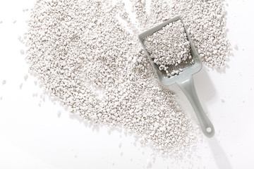 sand for cats and scoop for cleaning. on a white background