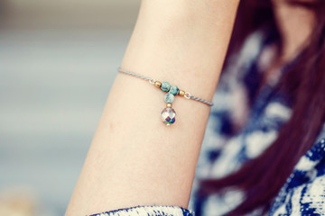 Female wrist wearing tiny jewelry bracelet with mineral stone beads - 266572526
