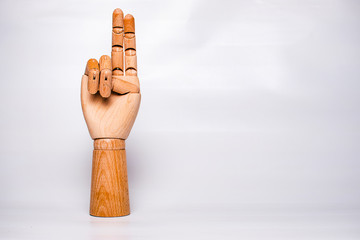 A wooden orthopedic hand on white background.