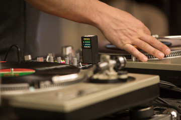 DJ hands mixing records on turntable