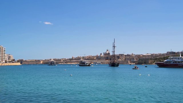 A vintage two mats sailing boat in front of Valletta, Malta