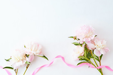 Fototapeta premium Flat lay composition with light pink peonies on a white background