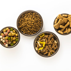 pet food in bowls and toys isolated on white background