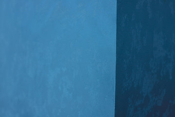 Blue concrete wall, textured background.