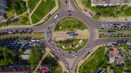 Overhead drone shot of beautiful park and busy roundabout
