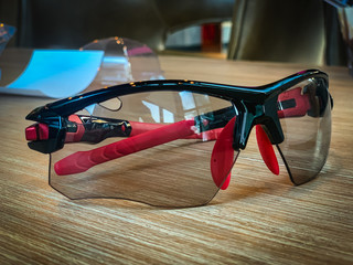 Black and red sunglasses Placed on the table blurry background