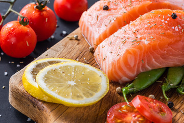 diet healthy food concept, raw fresh salmon fillet and ingredients on wooden background