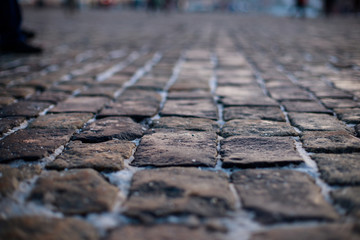 Stone pavement in perspective. Old street paved with stone blocks. Shallow depth of field. Vintage...