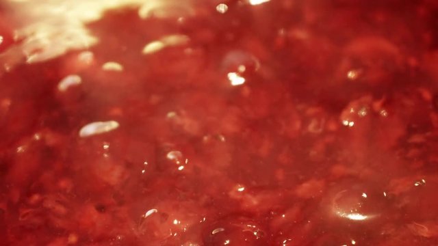 Slow cooking jelly kissel with fresh strawberries, red currants and gooseberries, traditional Russian summer drink, close up video