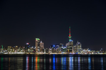Fototapeta na wymiar Auckland skyline at night reflecting in ocean