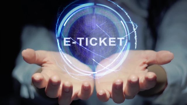 Female hands show a round conceptual hologram with text E-ticket. Unrecognizable woman in ashen white on a black background with future holographic technology