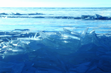Sun rays are refracted by the transparent ice of Lake Baikal. crystal clear ice fragments — hummocks