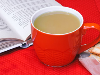 Cup of coffee, dry cracker cookies and dry leaves on an orange background. Autumn background, flat lay. Autumn composition. Autumn mood, top view. Cup of autumn coffee and yellow dry leaves.
