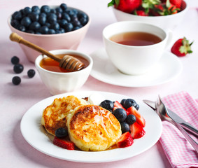 Cottage cheese pancakes with honey and berries for breakfast or lunch