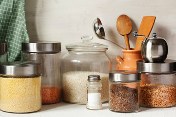Glass jars with legumes, groats and useful seeds. Healthy vegetarian food. Clean eating concept
