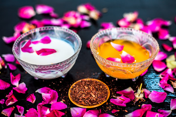 Milk face pack for clear complexion on shiny black wooden surface i.e. Raw milk well mixed with...