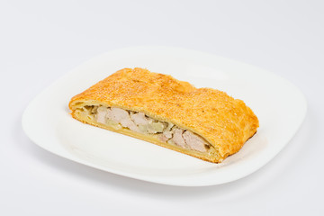 slice of chicken pie on a plate isolated on white