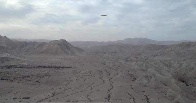 Stealth Bomber drops bombs on mountain aerial view Powerful Video Compositing simulates Real drone footage with visual effect elements of Stealth Bomber droping bombs on mountain