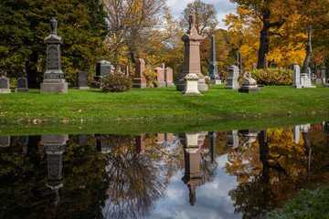Montreal / Canada - Oct. 25, 2017: Autumn reflection and grave stones, Mont-Royal Cemetery,...