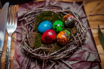 colorful Easter eggs quail in the nest