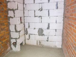 Concrete and brick walls in the apartment for repair