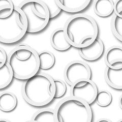 Abstract seamless pattern of randomly arranged gray rings with soft shadows on white background
