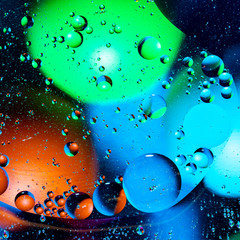 Mixing water and oil on a beautiful color abstract background gradient balls circles and ovals
