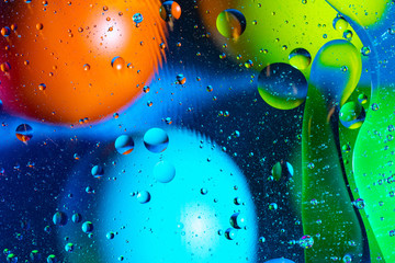 Mixing water and oil on a beautiful color abstract background gradient balls circles and ovals