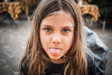 Portrait of a young girl with tongue sticking out