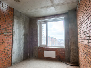 Fototapeta premium Concrete and brick walls in the apartment for repair