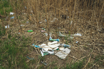 Environmental pollution. Garbage in nature. Plastic bottles and cellophane bags in the river