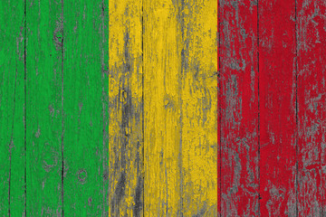 Flag of Mali painted on worn out wooden texture background.