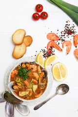 French seafood soup. Bouillabaisse ear of seafood. Food French sailors. White background, top view. Free space for inscriptions. Still life concept.