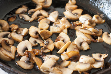 White champignons with mushrooms, fried in a pan, cooking ingredients for soup, salad. Vegetarian healthy protein food for the main course, lifestyle