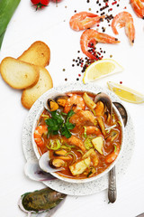 French seafood soup. Bouillabaisse ear of seafood. Food French sailors. White background, top view. Free space for inscriptions. Still life concept.
