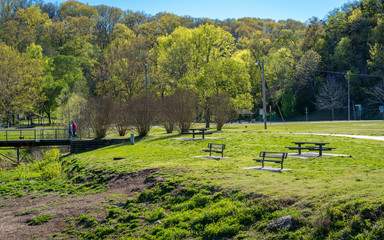 Benches in the sun, spring in the park hiking trail at Bella Vista Lake Park, Northwest Arkansas