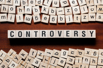 Controversy word concept on cubes