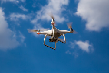 Quadcopter in flight against a blue sky. Drone.