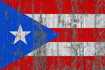 Flag of Puerto Rico painted on worn out wooden texture background.