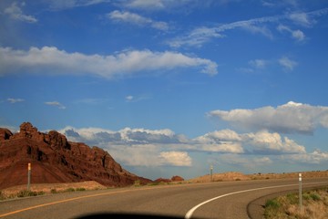 Dragon Canyon in Utah. Clear sunny weather, beautiful landscape. Eroded landscape in the Black Dragon Canyon, Utah. The sky is clear, the clouds. Red kayon minerals. In the foreground desert plants