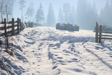 Fresh morning in the snowy mountains at a ski resort. Snow-covered wooden houses