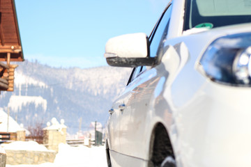 The car is white in the snow. Rubber on wheels in the snow. Snowy mountains of the Carpathians