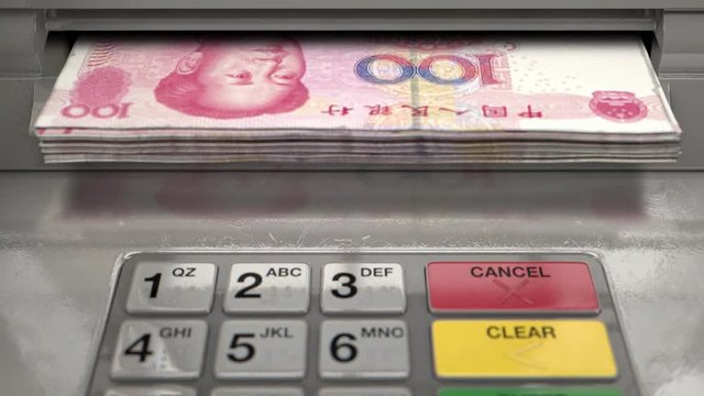 A closeup view of an atm facade with an illuminated sceen and keypad and a wad of yuan banknotes being ejected from the cash slot 