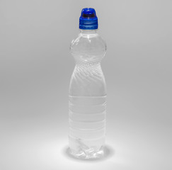 Transparent plastic bottle with a blue cork with a drinker filled with water