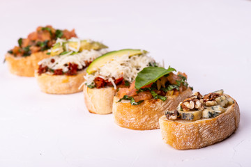 Delicious Italian antipasti bruschetta on white background. Macro.