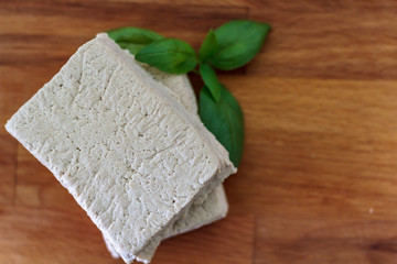 Top view of white tofu on wooden board
