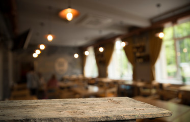 Empty wooden table in front of abstract blurred background of coffee shop . can be used for display or montage your products.Mock up for display of product