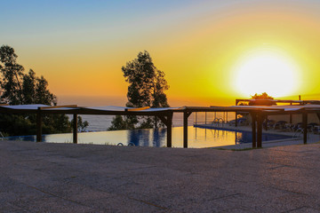 Fototapeta na wymiar Amazing Sunset by the pool on Nazaré, Portugal