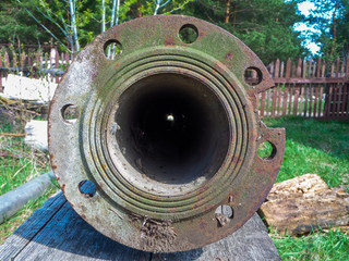 Old rusty pipe through which light is visible.