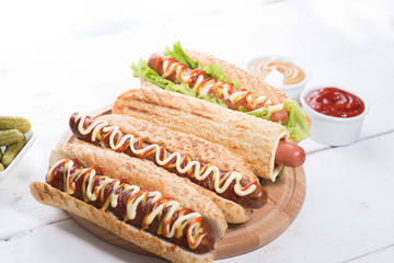 many different hot dogs with sauces on the table